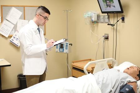 Garret Steelman, pharmacy student, runs through a simulation in Providence Hall. - Photo by Kristi McMurry Woody