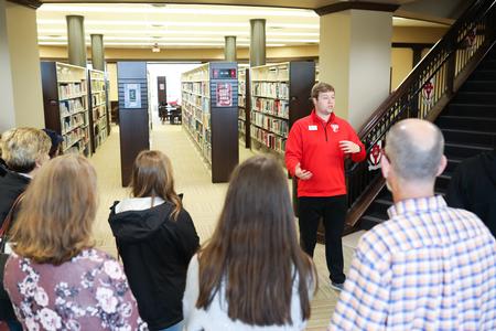 Luke McCormack, enrollment counselor, leads a tour through the library during Day at the U. - Photo by Kristi McMurry Woody