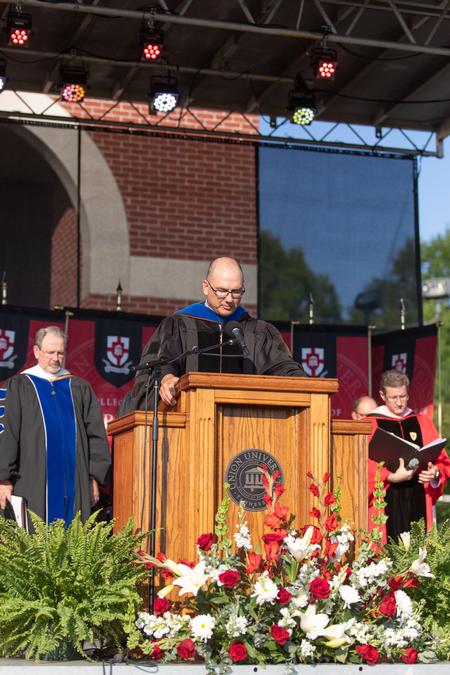 Michael Salazar, professor of chemistry, prays at the beginning of Spring Commencement. - Photo by Kristi McMurry Woody