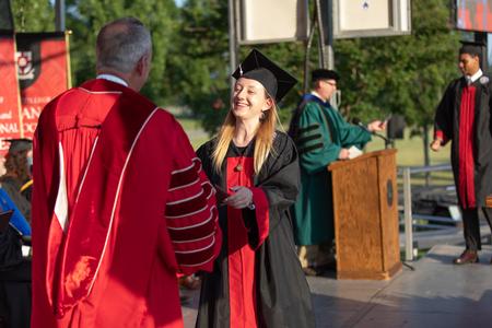Nikki Grim, art graduate, receives her diploma during Spring Commencement. - Photo by Kristi McMurry Woody
