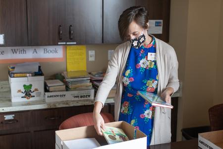Olivia Chin, circulation manager, sorts returned books in the library. - Photo by Kristi McMurry Woody
