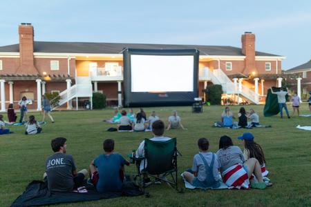 Students enjoy a movie outdoors during Welcome Week SAC Fest. - Photo by Kristi McMurry Woody