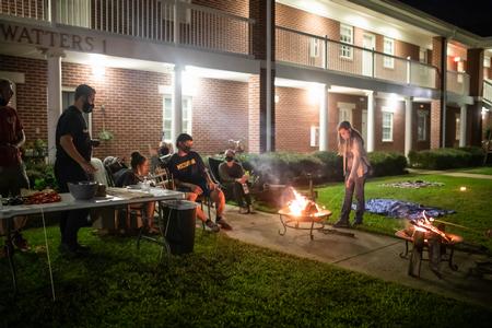 Students roast s'mores outside the apartment of Nathan Heatherly, graduate assistant, during Residence Life's Progressive Snacking. - Photo by Kristi McMurry Woody