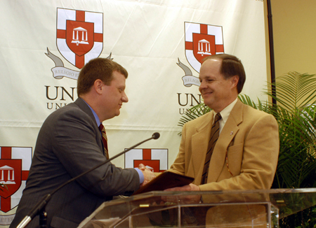 Alumni Association president Jerome Teel presents Chairman of Union's board of trustees Michael Weeks with the Honorary Alumnus Award during the Homecoming awards luncheon.  - Photo by Morris Abernathy