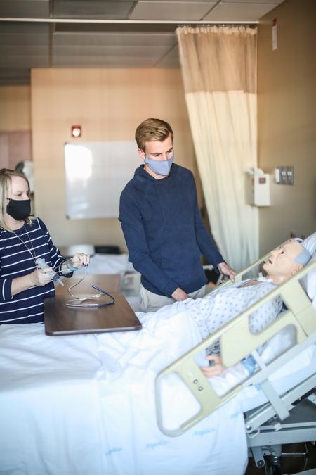 10/6/20 - Jennifer Delk, assistant professor of nursing, and Nathanael Dean, senior nursing major, work in one of the simulation labs in Providence Hall. - Kristi McMurry Woody