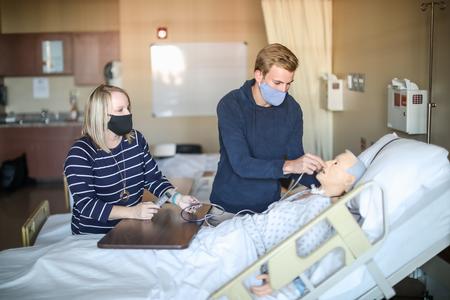10/6/20 - Jennifer Delk, assistant professor of nursing, and Nathanael Dean, senior nursing major, work in one of the simulation labs in Providence Hall. - Kristi McMurry Woody