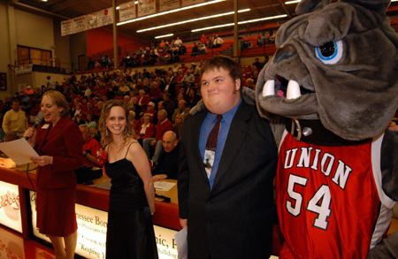 Dean of Student Kimberly Thornbury introduces seniors Lindsay Grace Brown and Jonathan Blair as the newly elected Mr. & Miss Union during the Homecoming basketball games. Jonathan gets a special congratulation from Buster. - Photo by Morris Abernathy