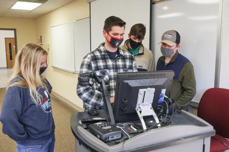 Students in Enactus work on the cyber recycling program during Campus and Community Day. - Photo by Sarah Palmer Goff