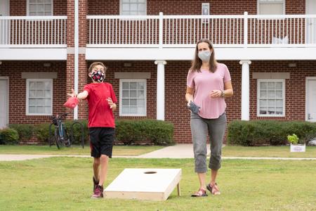 Students and their families enjoy a cornhole tournament during Family Weekend. - Photo by Naomi Mengel