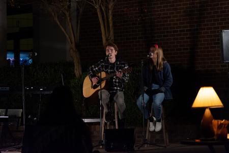 Students perform outside Barefoots Joe during Open Mic Night. - Photo by Naomi Mengel