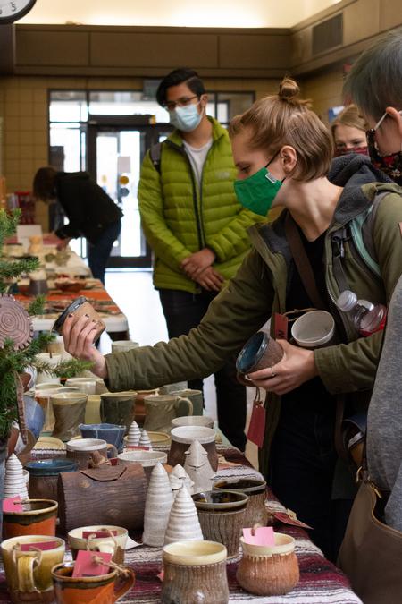 Students shop the annual Christmas pottery sale. - Photo by Naomi Mengel