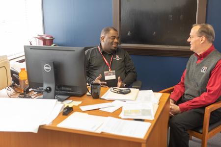 Leon Jones, director for recruitment at MCUTS, chats with Greg Hollifield, associate dean for assessment and reporting at MCUTS. - Photo by Kristi McMurry Woody