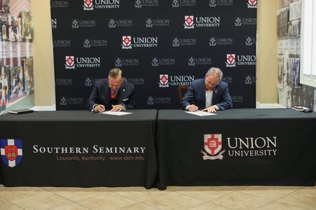 Dub Oliver (right), president of the university and Southern Seminary President R. Albert Mohler Jr. sign a partnership agreement between the two institutions. - Photo by Kristi McMurry Woody