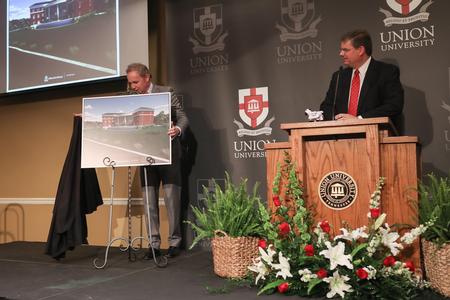 Dub Oliver, president of the university, presents a new building plan during the Faith in the Marketplace luncheon. - Photo by Kristi McMurry Woody