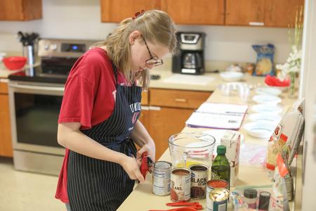 Kari Hudnell, EDGE student, works on her senior seminar cooking lab project. - Photo by Kristi McMurry Woody