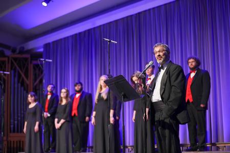 Paul Randlett, associate professor of music and worship studies, introduces the next song during the annual Spring Choral Concert.  - Photo by Kristi McMurry Woody