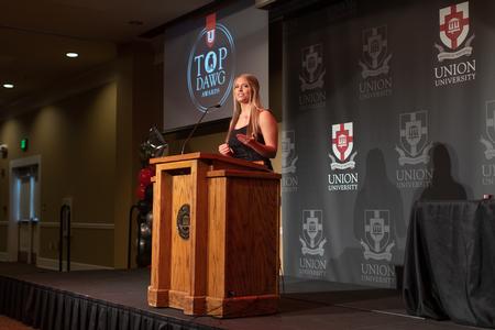 Kristen Pickens introduces award recipients at the Top Dawg Athletic Awards Banquet. - Photo by Kristi McMurry Woody