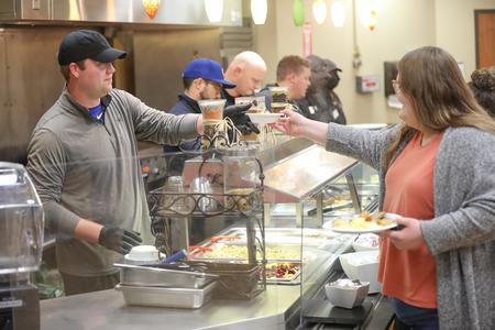 Faculty and staff serve students during Food for Finals in the cafeteria. - Photo by Kristi McMurry Woody