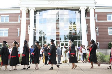 Graduates process to the Great Lawn for spring commencement. - Photo by Kristi McMurry Woody