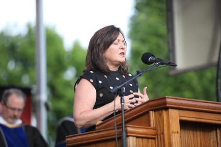 Robyn Hari opens spring commencement in prayer. - Photo by Kristi McMurry Woody