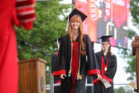 Sullivan Hogan, theatre graduate, walks across the stage to receive her diploma during spring commencement. - Photo by Kristi McMurry Woody