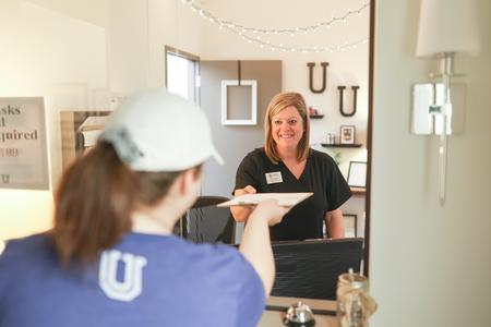 6/7/21 - Jennifer Chicantek, clinic assistant and health records coordinator, checks in a student at the Health Services Clinic. - Kristi McMurry Woody