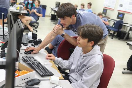 6/23/21 - Georg Pingen, professor of engineering, helps a camper with his design during 3D Printing Camp. - Kristi McMurry Woody