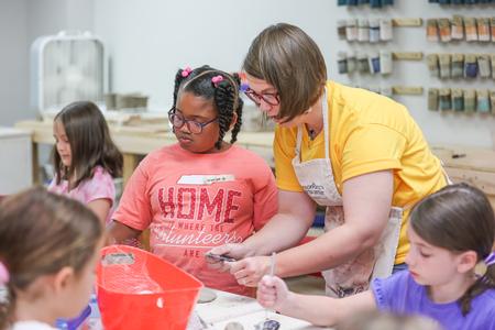 7/12/21 - Paige Ward, instructional staff, works with campers during a Ceramics Camp. - Kristi McMurry Woody