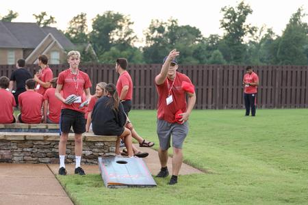 New students enjoy an ice cream party at the home of Dub Oliver during Welcome Week. - Photo by Kristi McMurry Woody
