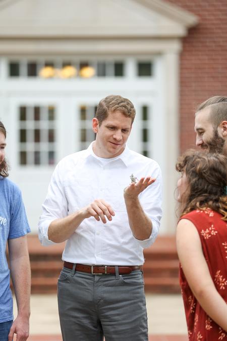Jeremy Blaschke, associate professor of biology, talks with students about a reptile the department is caring for. - Photo by Kristi McMurry Woody