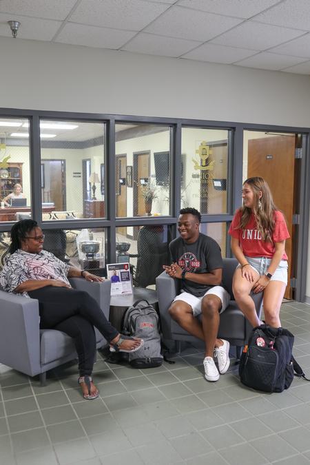 Janice Pittman, assistant professor of management, chats with her students, Steve Williams and Kailyn Martindale, in the BAC. - Photo by Kristi McMurry Woody