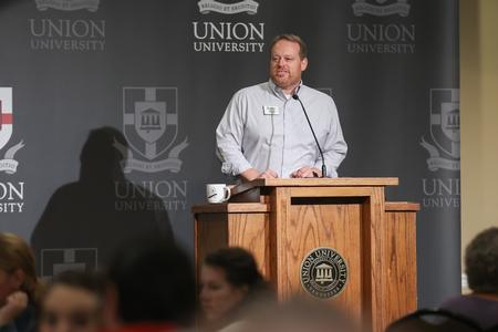 Ken Litscher, dean of student life and director for residence life, introduces Dub Oliver at the President's Brunch. - Photo by Kristi McMurry Woody