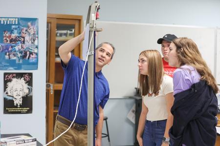 Fonsie Guilaran, professor of physics, works on a lab experiment with his class. - Photo by Kristi McMurry Woody