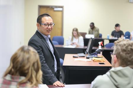 10/6/21 - Joseph Xu, associate professor of marketing, talks with students about an assignment before class. - Kristi McMurry Woody