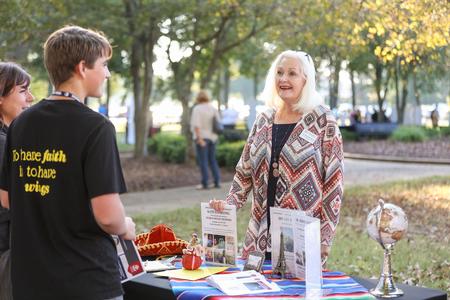 Jean Marie Walls, professor of language and department chair, talks with prospective students during the Day at the U academic fair. - Photo by Kristi McMurry Woody