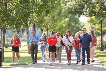 Student ambassadors give a tour of campus to prospective students and their families during Day at the U. - Photo by Kristi McMurry Woody