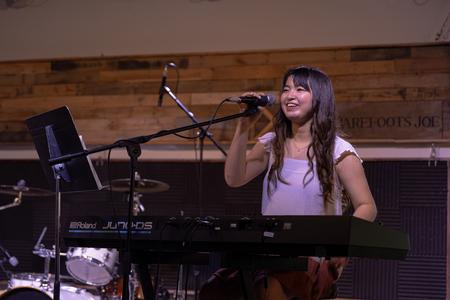 Eunice Tan, English major, performs during Open Mic Night in Barefoots Joe. - Photo by Cade Smith