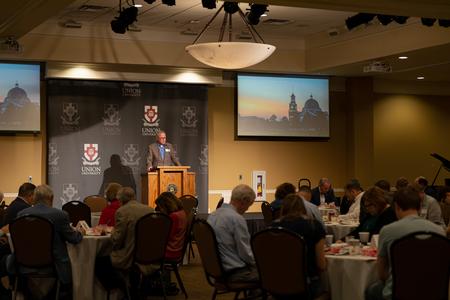Todd Brady, vice president for university ministries, leads guests in prayer during a Prayer Breakfast in the Grant Center. - Photo by Cade Smith