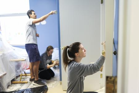 Students paint at All Saints Church in Jackson during Campus & Community Day. - Photo by Kristi McMurry Woody