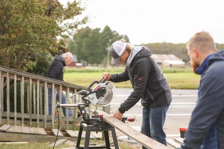 The men's golf team works on building a deck at Northbrook Church during Campus & Community Day. - Photo by Kristi McMurry Woody