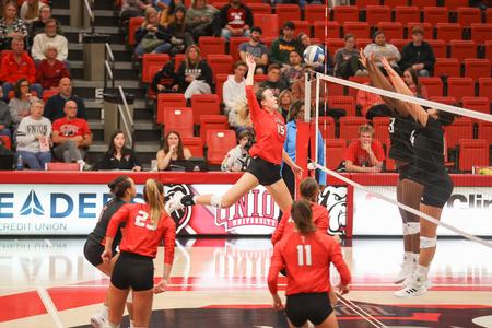 Emily Grace Calhoon spikes the ball in a volleyball game against University of West Alabama. - Photo by Kristi McMurry Woody