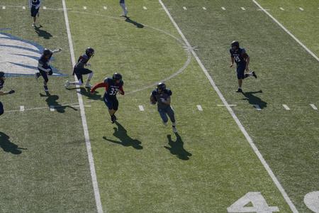 Alumni, students and employees play a game of football for the Homecoming 2021 Buster Bowl. - Photo by Abigail Aspinwall