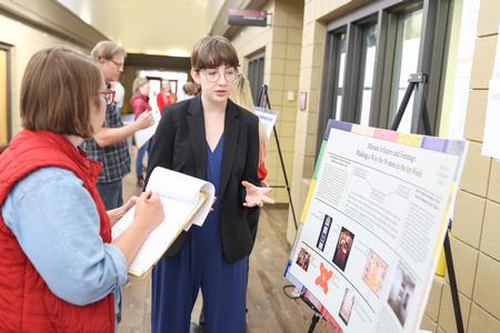 Elaina Fuller, studio art major, presents her research during Fall Poster Sessions. - Photo by Kristi McMurry Woody