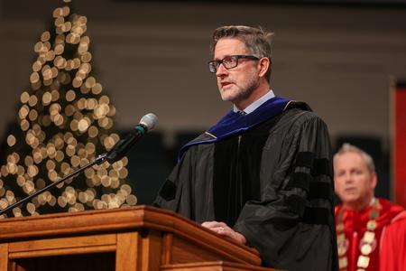 12/11/21 - Michael Schiebout, associate professor of biology, gives the scripture reading at the beginning of fall graduation. - Kristi McMurry Woody