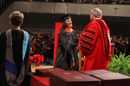Allison Rasnic, master of science in nursing graduate, receives her diploma. - Photo by Kristi McMurry Woody