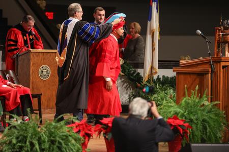 12/11/21 - Deanté Alexander, doctor of education graduate, receives his doctoral hood during fall graduation.  - Kristi McMurry Woody