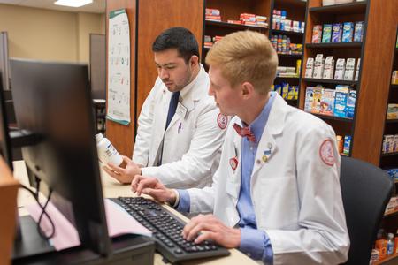 Pharmacy students work in the OTC lab in Providence Hall. - Photo by Kristi McMurry Woody