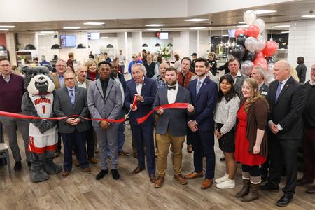 Students, employees and contractors participate in the ribbon cutting for the renovated Brewer Dining Hall. - Photo by Kristi McMurry Woody