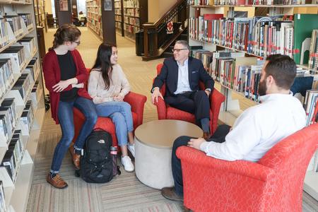 Keith Bates, professor of history, chats with students in the Logos. - Photo by Kristi McMurry Woody