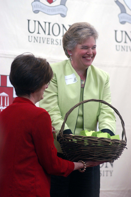 Women's Auxiliary President Lanese Dockery draws names for door prizes at the group's Spring Luncheon. - Photo by Morris Abernathy